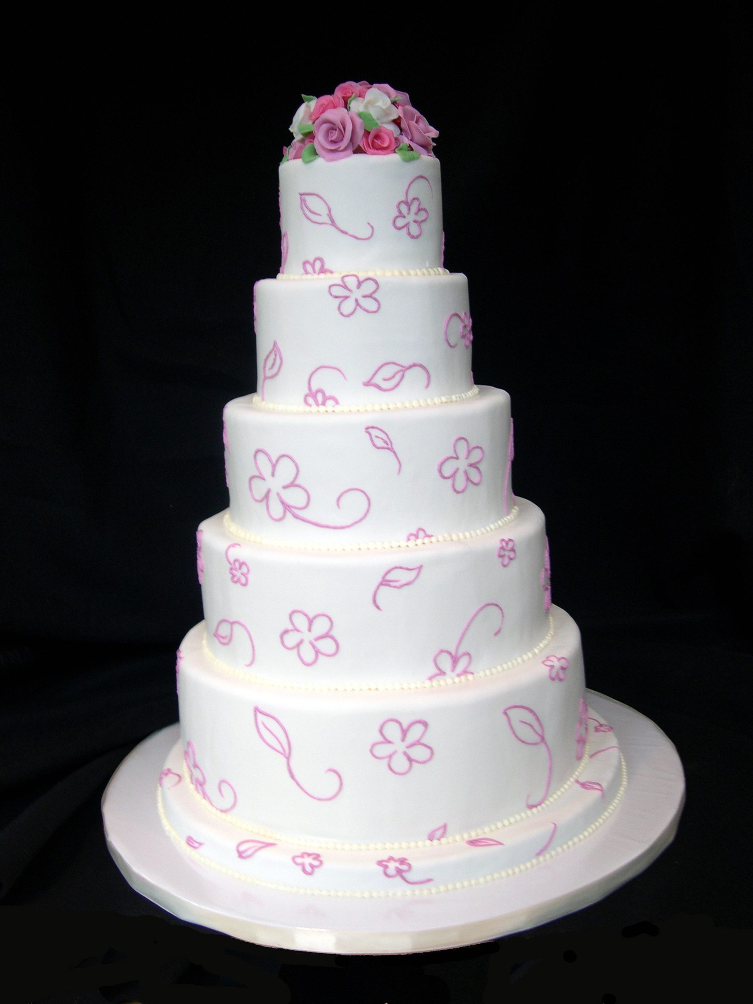 Five-tier wedding cake with piped lavender flowers